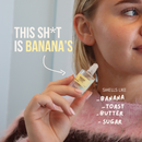 Woman holding a 12ml clear glass roll-on Banana Toast perfume oil bottle with a yellow label.