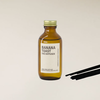 Banana Toast fragranced diffuser in amber bottle with reed sticks