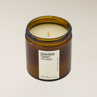 Amberjack Banana Toast soy candle in a brown glass jar with a cream label, 400gm size.