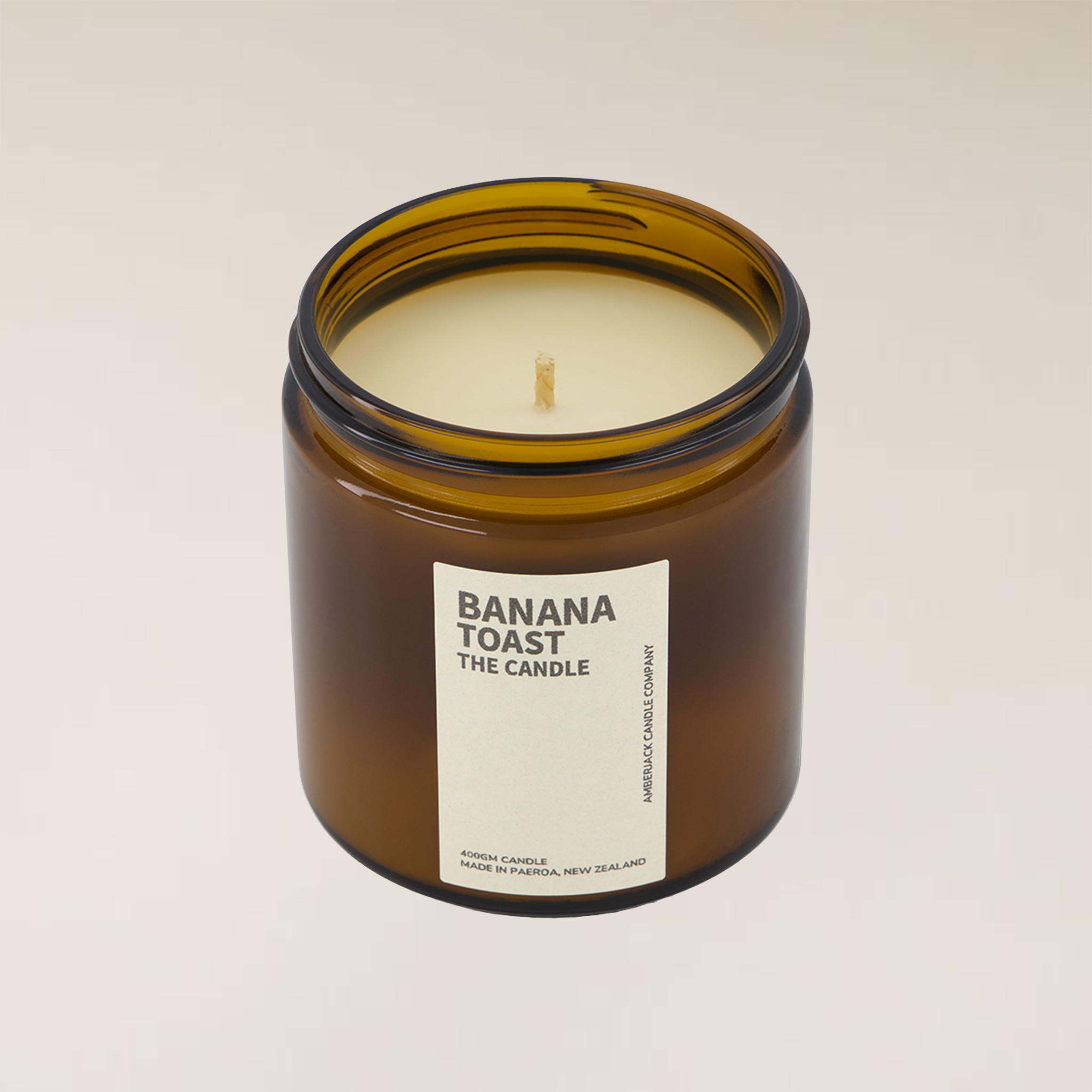 Amberjack Banana Toast soy candle in a brown glass jar with a cream label, 400gm size.