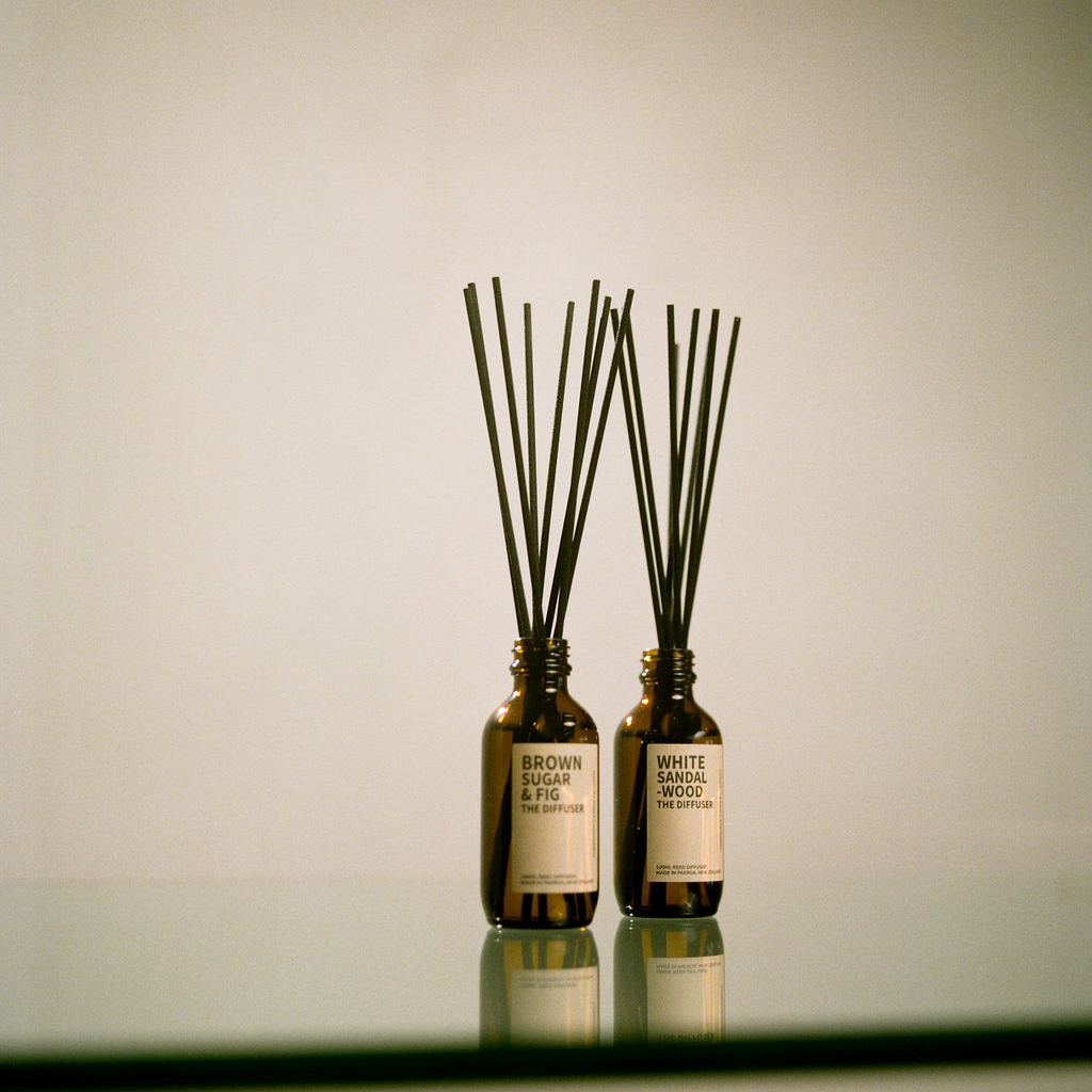 2 Diffusers made by Amberjack sitting on a glass table 