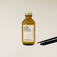 Dark Vanilla 100ml amber glass reed diffuser with gold cap and black reed sticks.