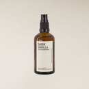 Dark Vanilla 100ml room spray in an amber glass bottle with a black pump sprayer and cream label.