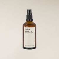Dark Vanilla 100ml room spray in an amber glass bottle with a black pump sprayer and cream label.