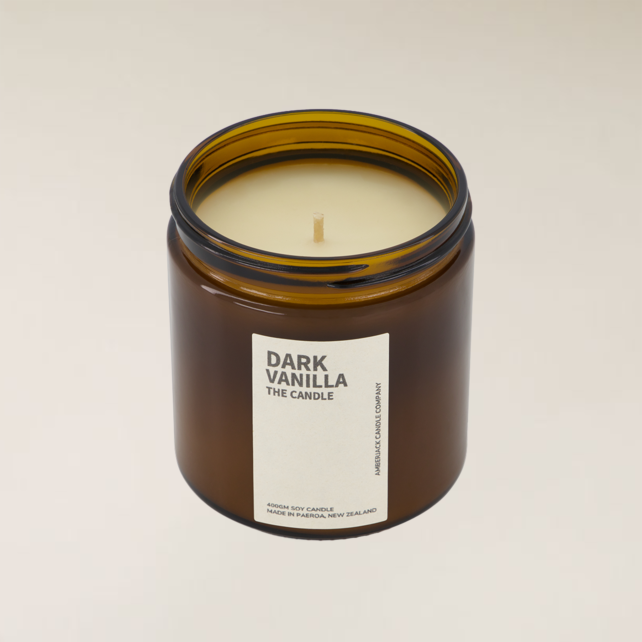 Dark Vanilla 400gm soy candle in a brown amber glass jar with a cream label and single wick.