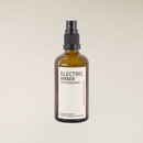 Electric Amber 100ml roomspray in an amber glass bottle with a black spray top and white label.