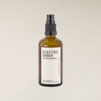 Electric Amber 100ml roomspray in an amber glass bottle with a black spray top and white label.