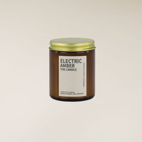 Electric Amber 150gm soy candle in a brown glass jar with a gold lid and cream label.