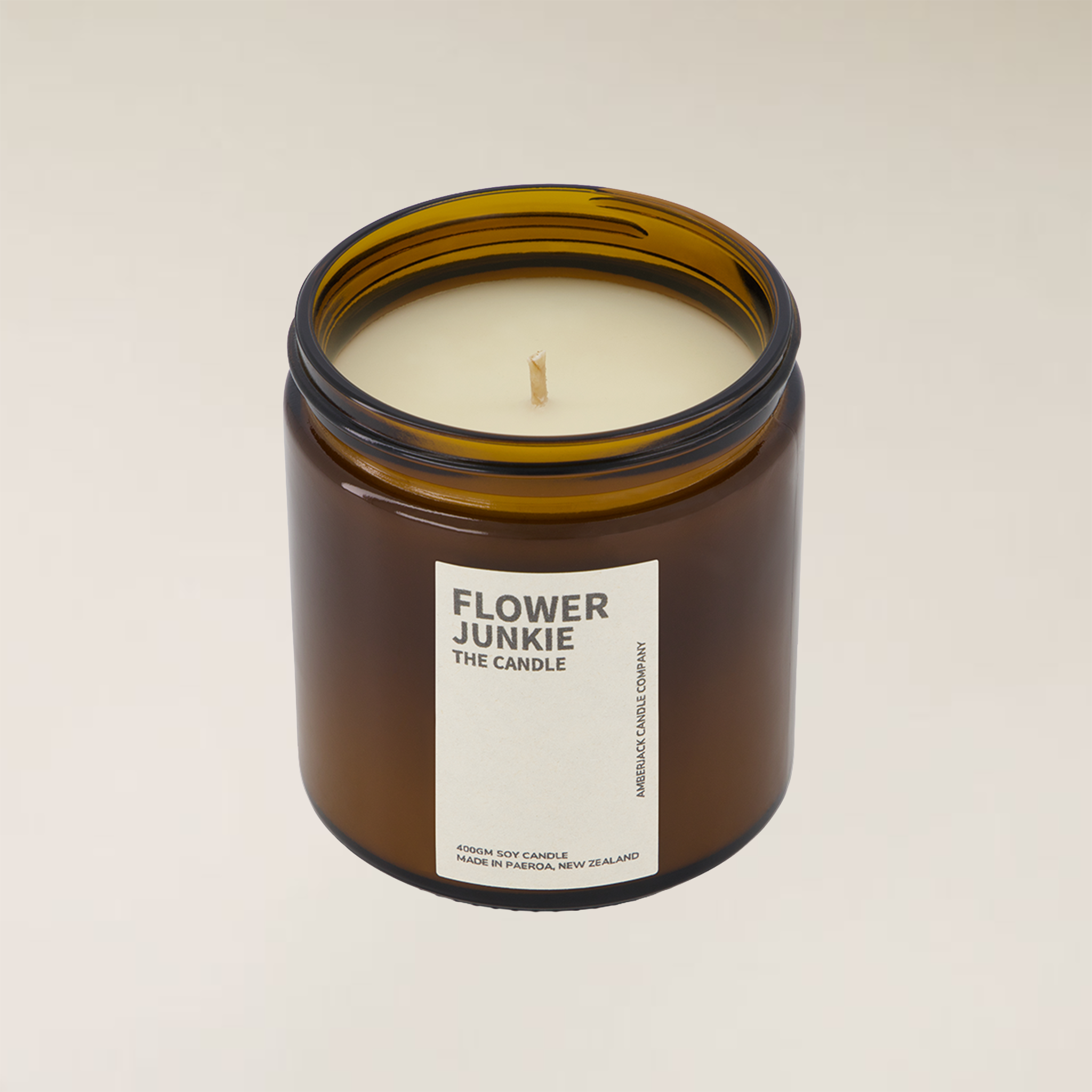 Amber brown glass jar "Flower Junkie" 400gm soy candle with a single wick on a light background.