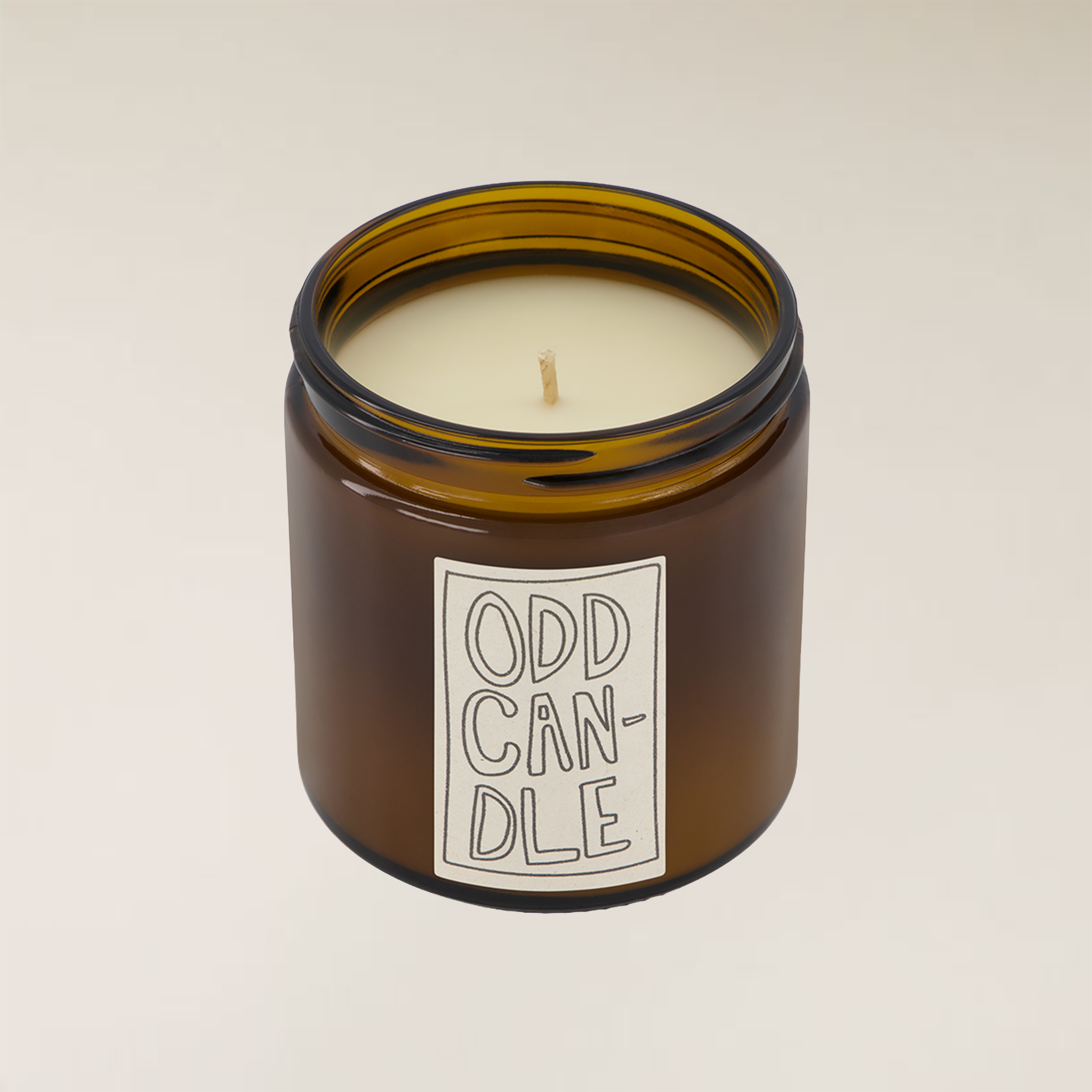 Odd Candle V3 in an amber glass jar with a cream wax and a white label.