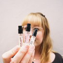Hand holding three 2.5ml perfume sample spray vials: Mister Vanilla, Rose Crush, and Brown Sugar & Fig.