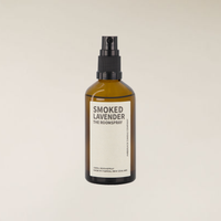 Amber glass 100ml Smoked Lavender room spray bottle with black pump on a light background.