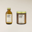 Two 'Flower Junkie' products, a diffuser bottle and a candle jar, on a beige background.