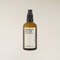 Amber brown glass 100ml "Whiskey In A Jar" room spray bottle with black pump and white label.