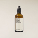Amber brown glass 100ml White Sandalwood room spray bottle with black pump on a light background.