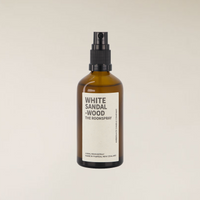 Amber brown glass 100ml White Sandalwood room spray bottle with black pump on a light background.