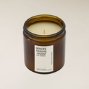 White Sandalwood soy candle in a brown amber glass jar with a cream label.