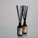 2 Diffusers made by Amberjack sitting on a glass surface